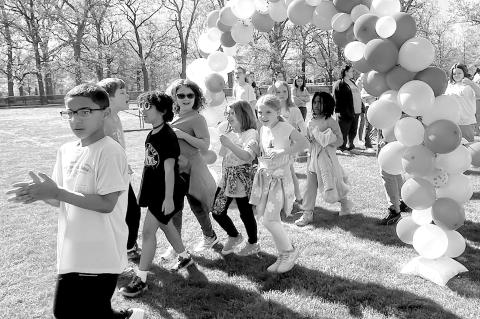 KINDNESS AND CONNECTION: Collingswood students walk through a balloon arch in Knight Park to celebrate Autism Acceptance Month.