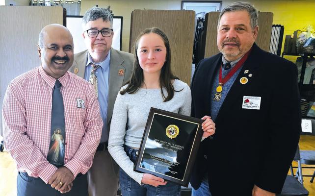 THEN THERE WAS ONE: Izzy Klawitter, center, outlasted fellow spelling experts to win the New Jersey Knights of Columbus 2024 spelling bee championship on Sunday. She was congratulated by, from left, Rolland Couthino, South Jersey spelling bee chairman; Raymond Lillie, New Jersey spelling bee chairman and Raymond Sands, state deputy of New Jersey Knights of Columbus.